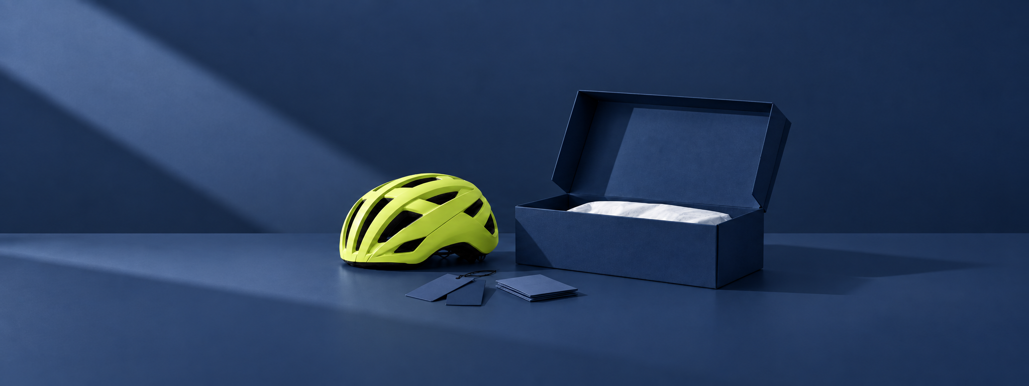 Branded helmet, hangtag, and inner box set on a packing table ready for a sample shipment